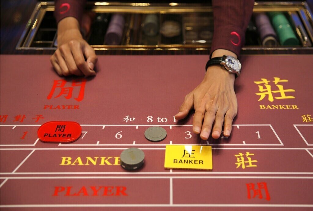 An image capturing a real-life Baccarat game with a bet placed on the banker.
